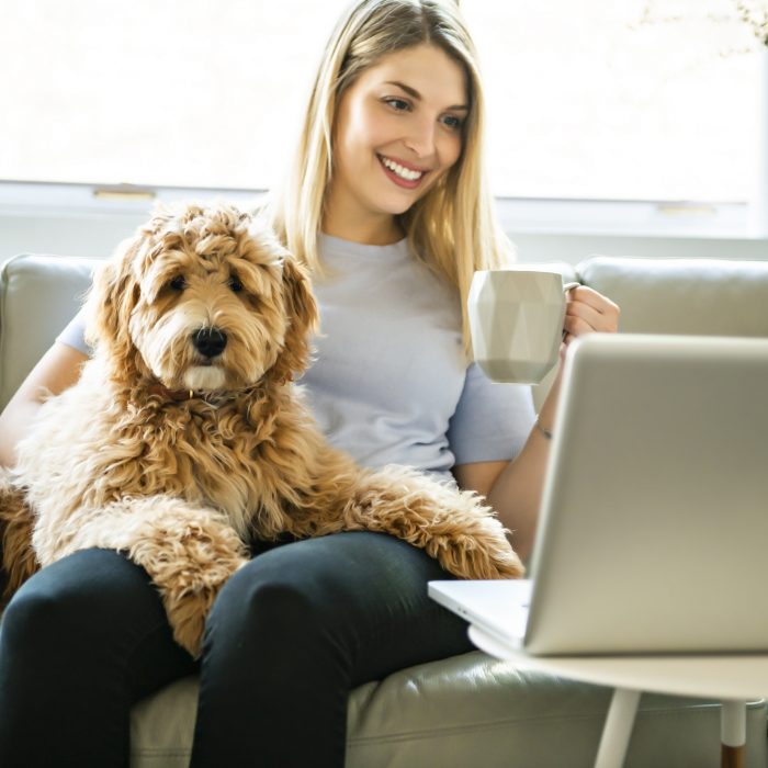 Woman sitting on couch with dog