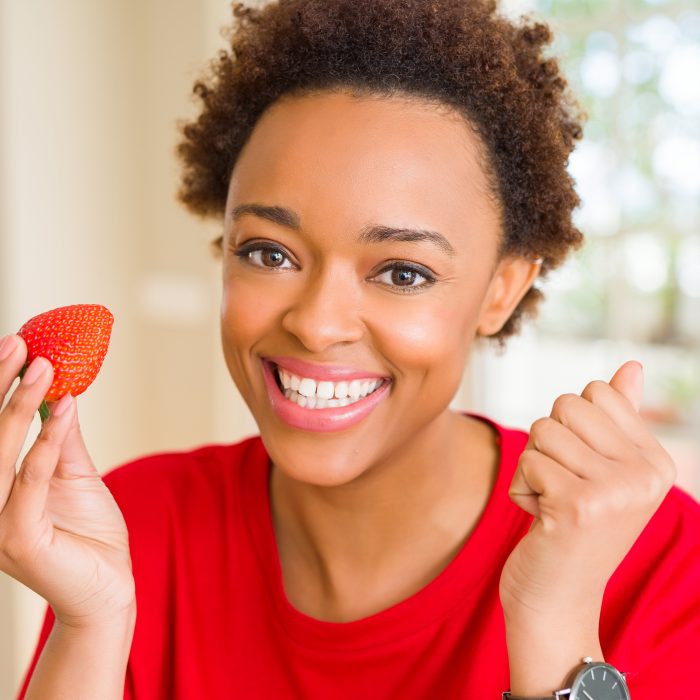 Woman eating strawberry