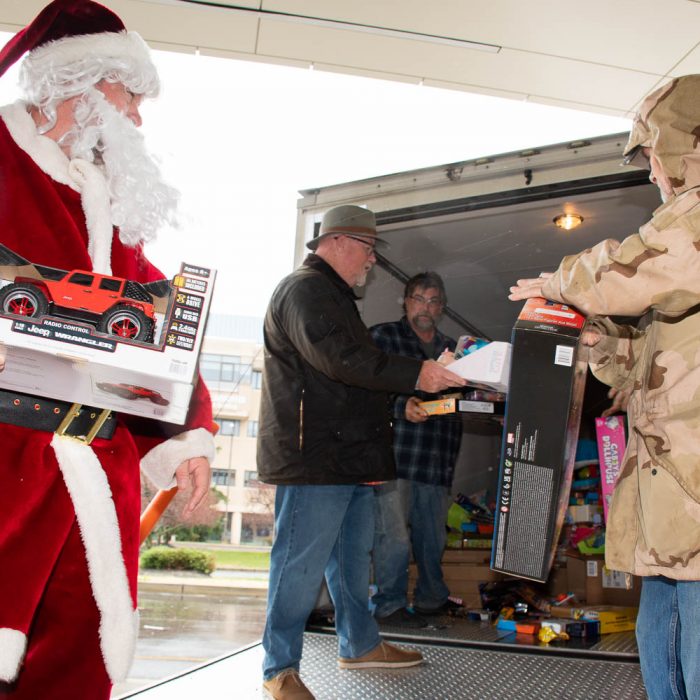 Unloading the truck and passing the toys down the line.