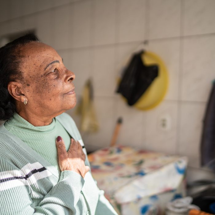 Contemplative senior woman looking away at home