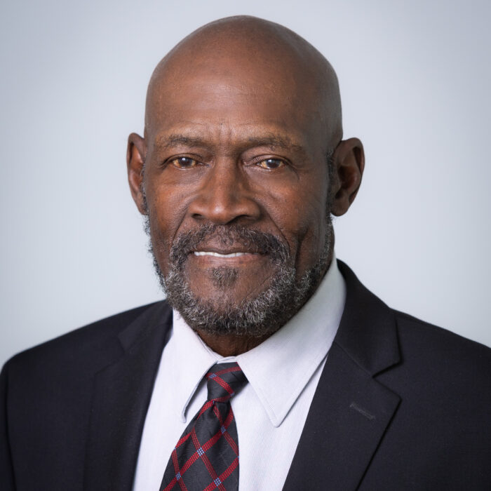 headshot of black man in suit and tie