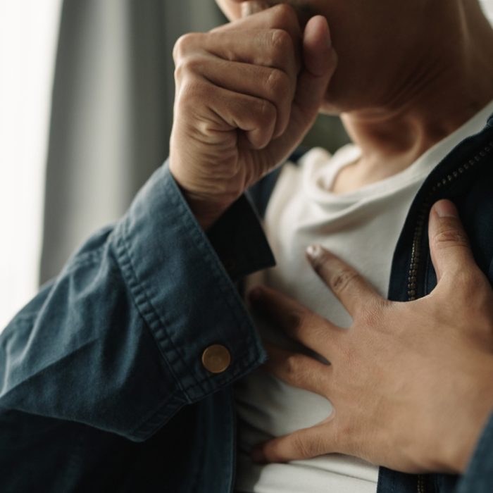 Young asian man was suffering from painful chest pain from a chronic disease.