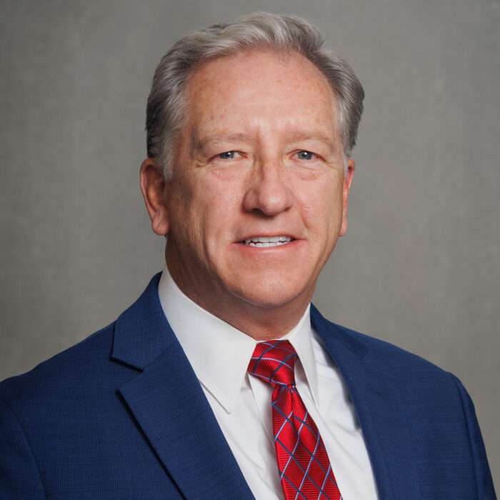 man in blue suit with red tie
