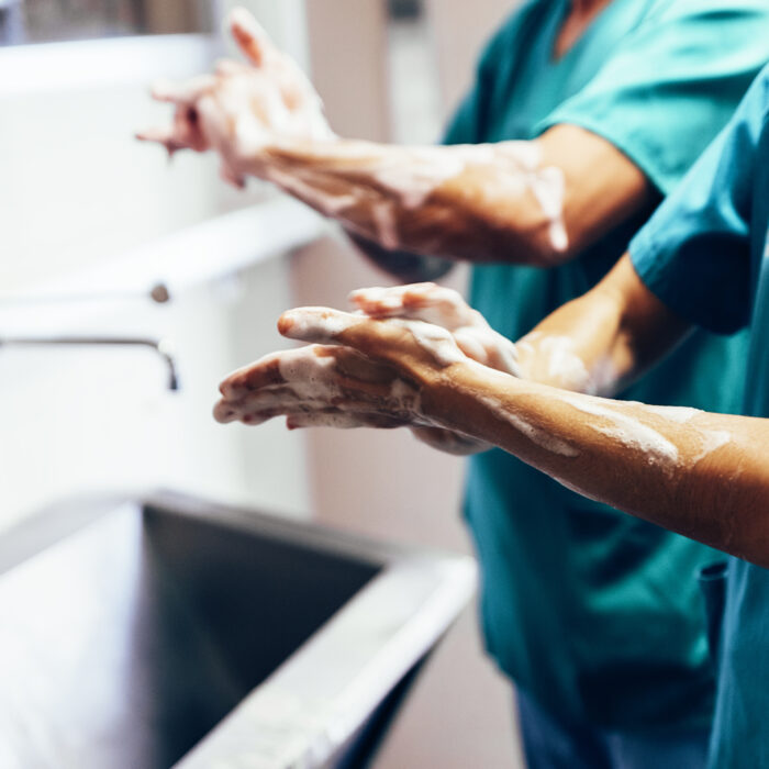 Couple of Surgeons Washing Hands Before Operating. Hospital Concept.