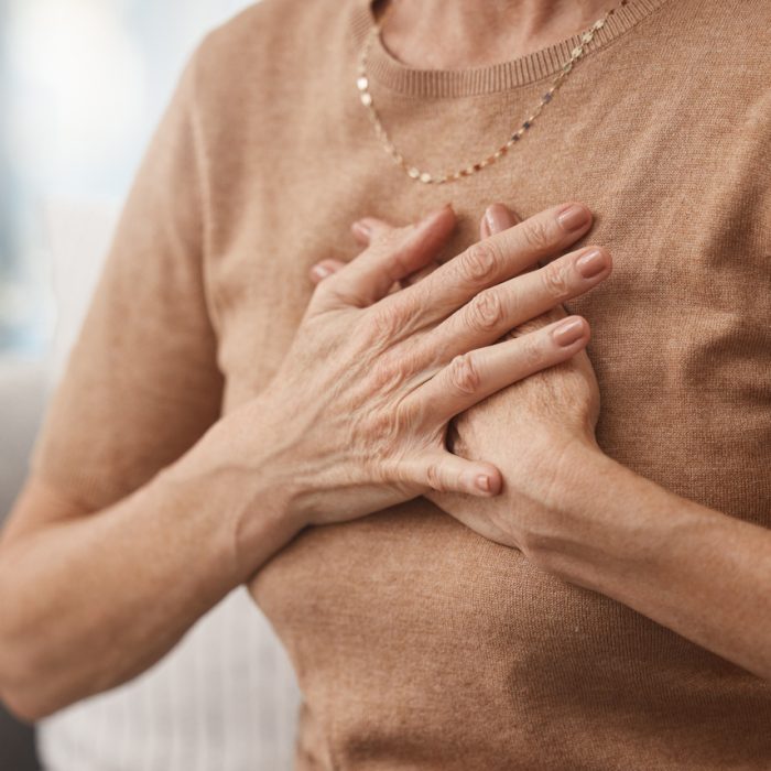 woman gripping chest