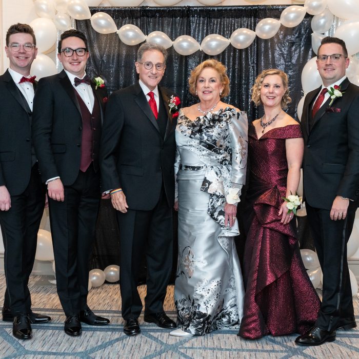 group of people in tuxes and gowns at a charity function