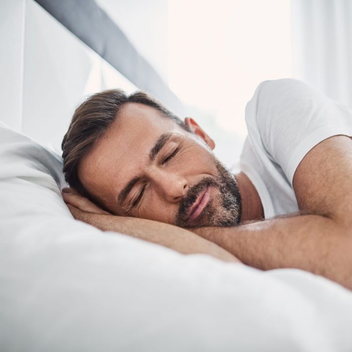 man sleeping in bed