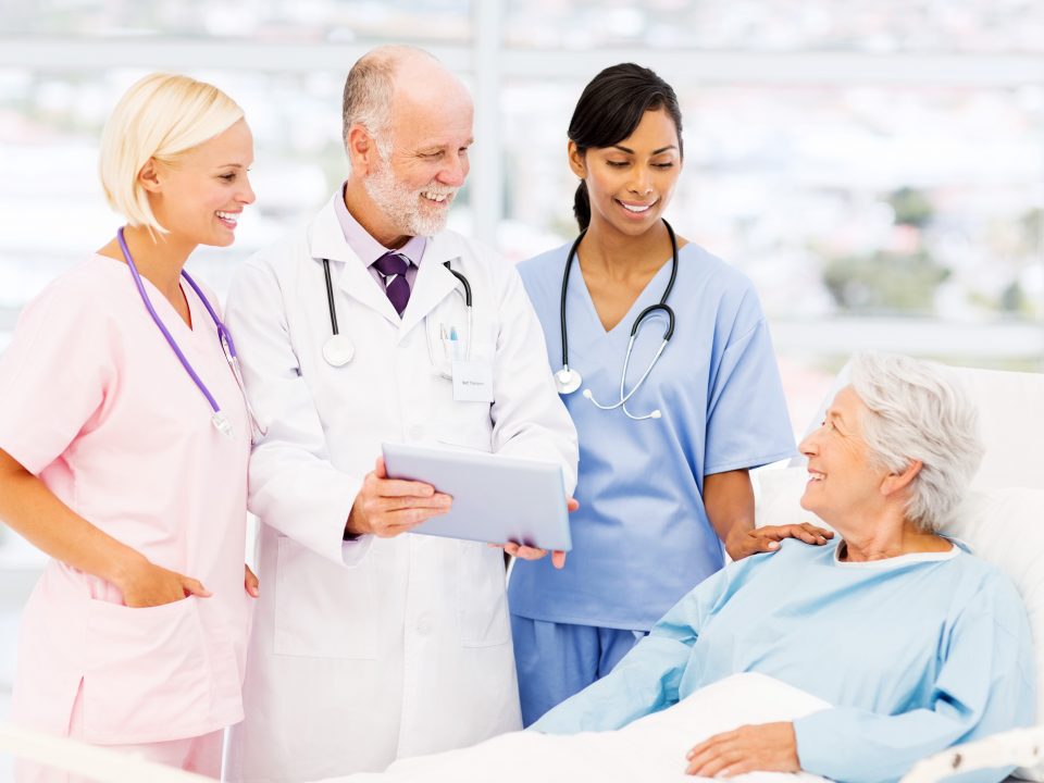 Medical Team Showing Reports To Patient In Hospital