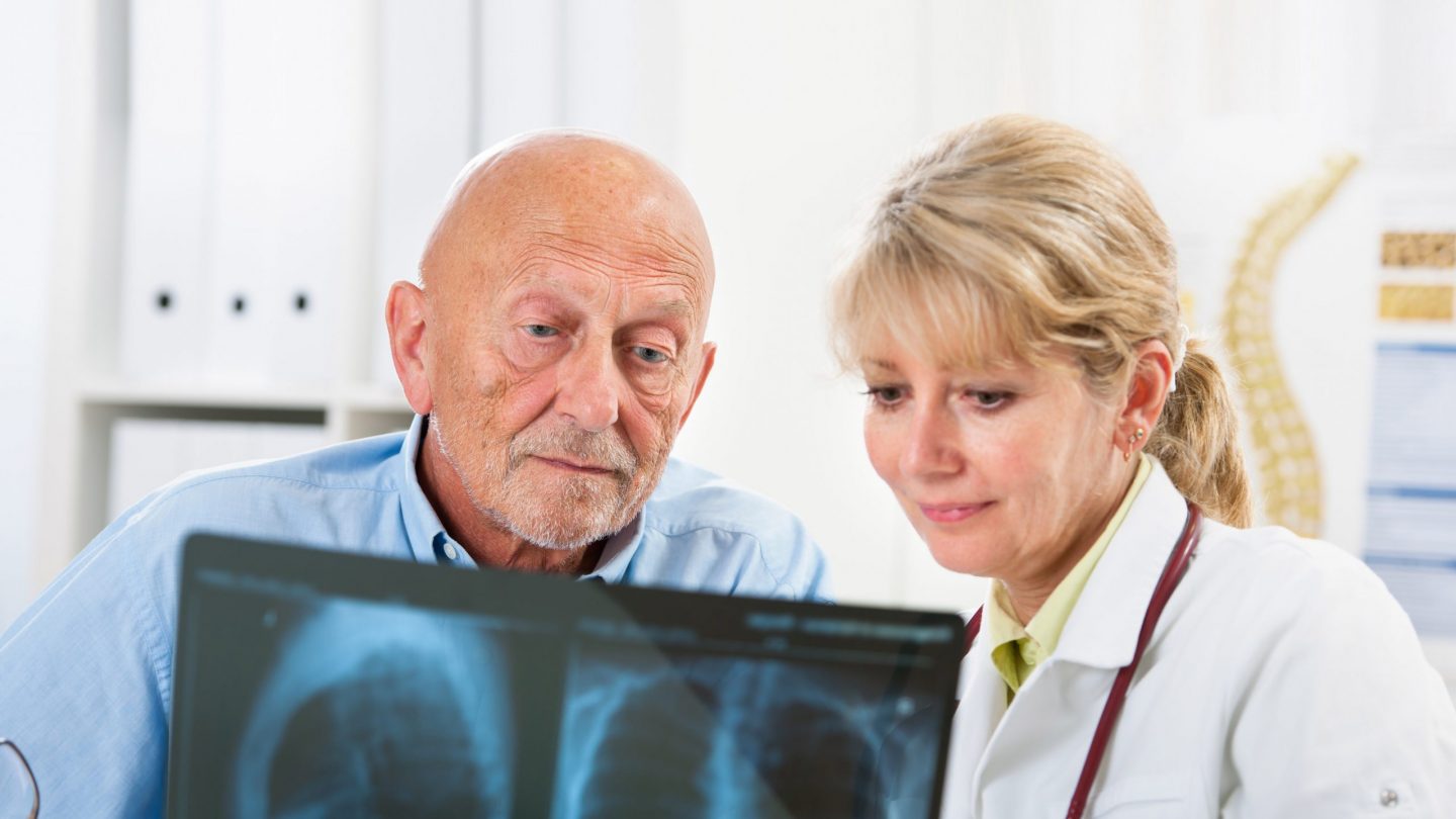 Lung Patient Examining X-Ray with Doctor