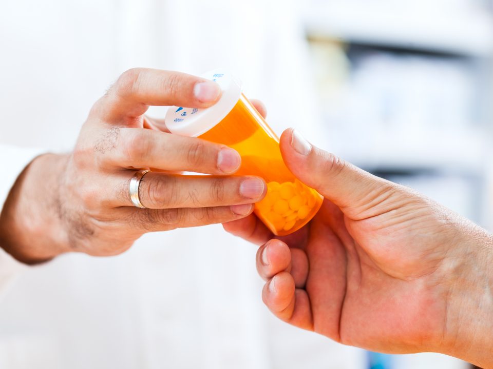 Pharmacist giving pills to customer