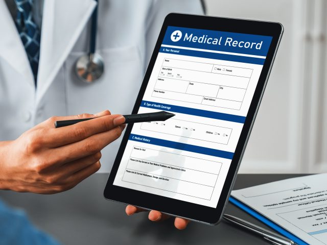 Doctor show medical diagnosis report on tablet and providing compassionate healthcare consultation to young couple patient in doctor clinic office. Medical appointment and healthcare concept. Neoteric